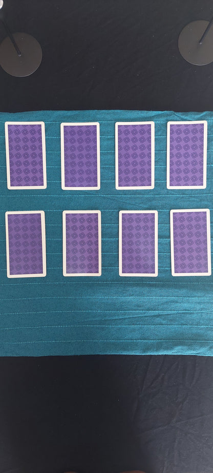 8 Tarot cards on a blue cloth facing down